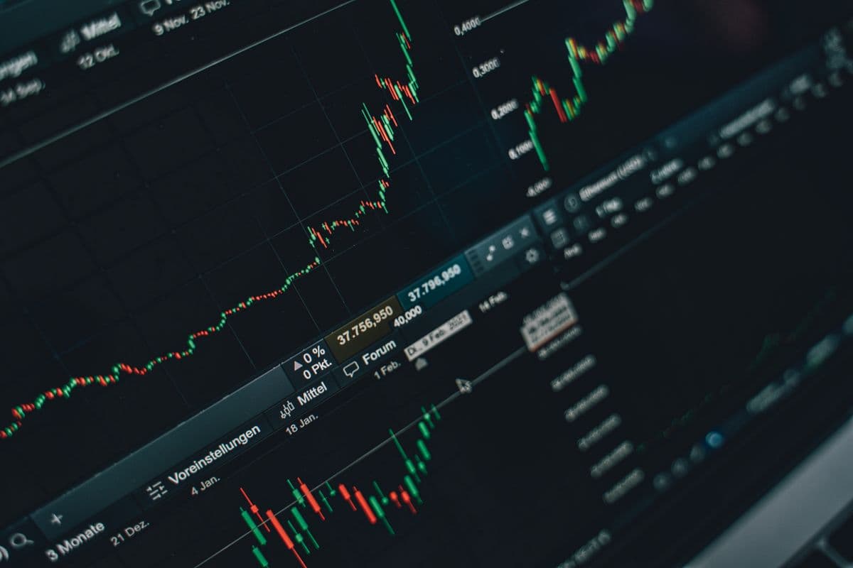Investor watching a trading chart on a laptop screen